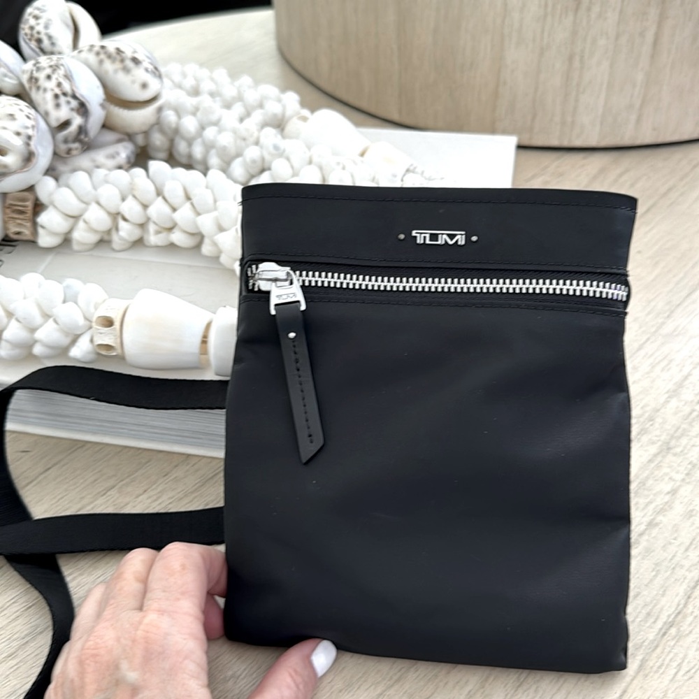 Tumi crossbody amazing to travel and carry passport and phone. Inside cc holder